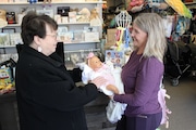 Owner Renee Garofalo, left, talks with a customer at Pete and Polly’s children's resale store in Brunswick.
