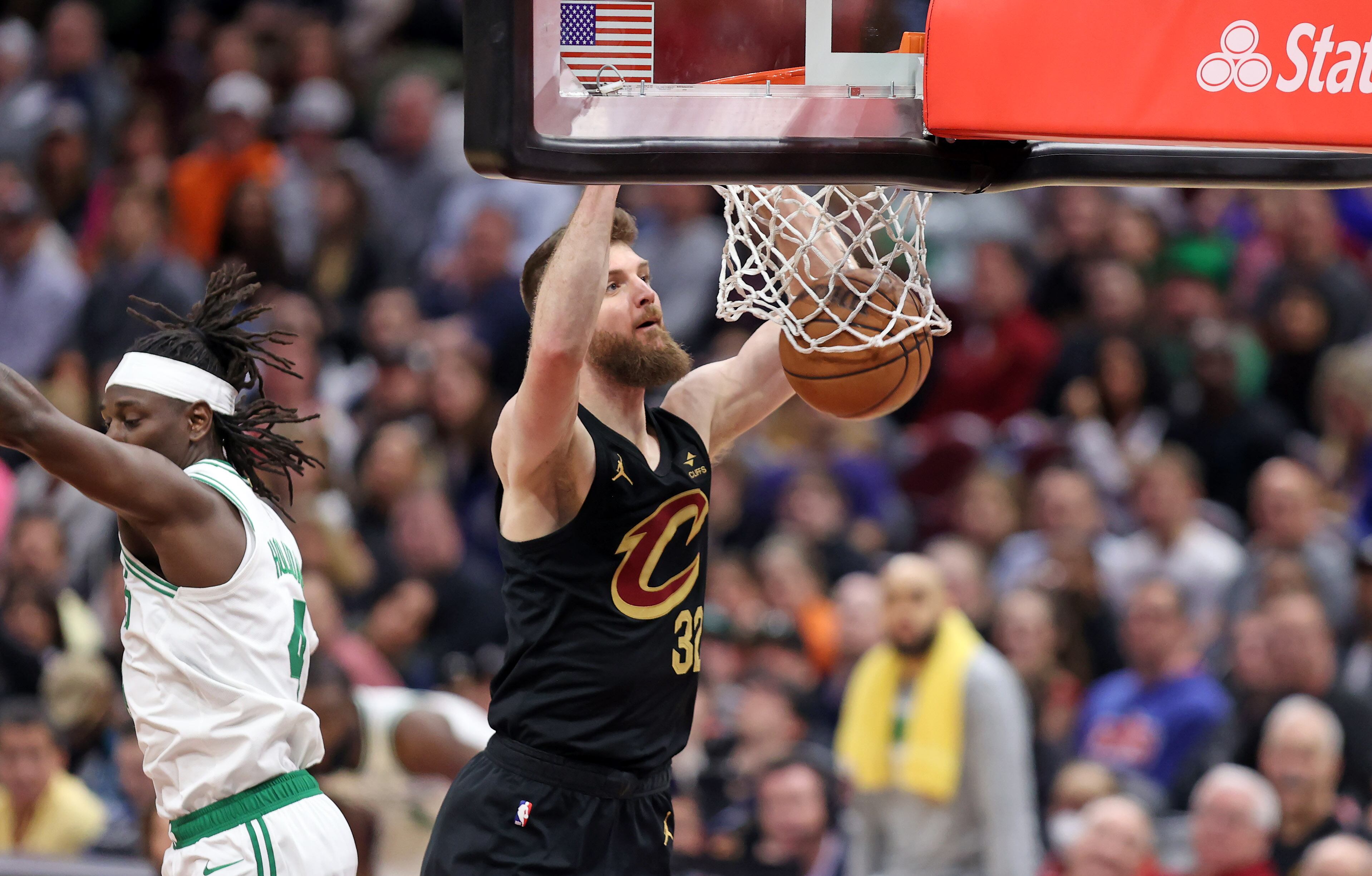 Cleveland Cavaliers forward Dean Wade dunks against Boston Celtics guard Jrue Holiday in the second half of play. 