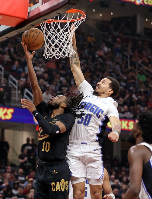 Orlando Magic guard Cole Anthony tries to block a shot from Cleveland Cavaliers guard Darius Garland in the first half of play.